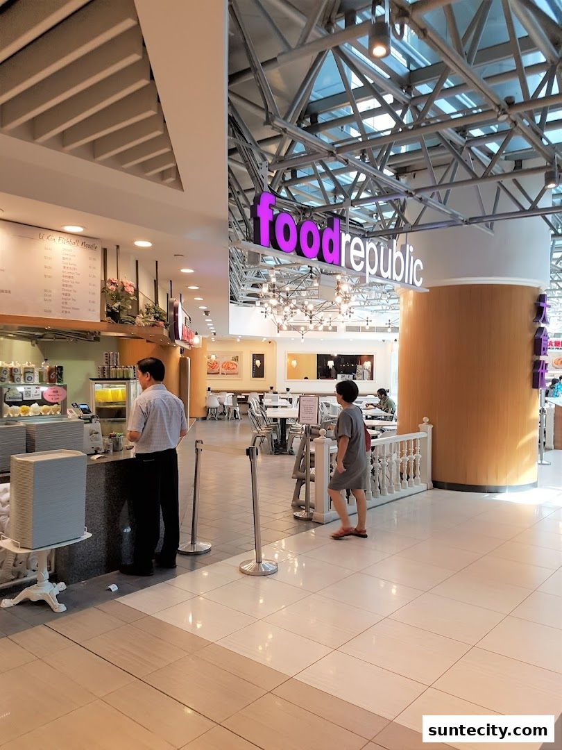 Interior view of a Food Republic food court with customers and signage.