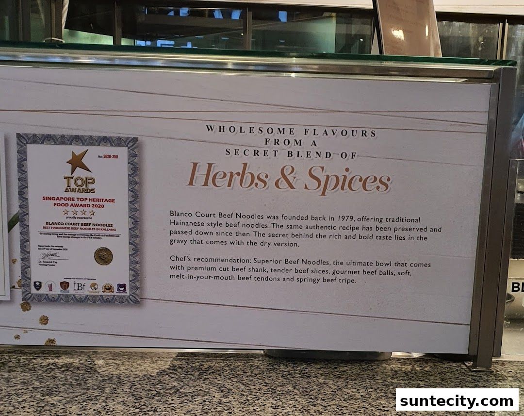 A sign for Blanco Court Beef Noodles, highlighting its heritage award and secret blend of herbs and spices.