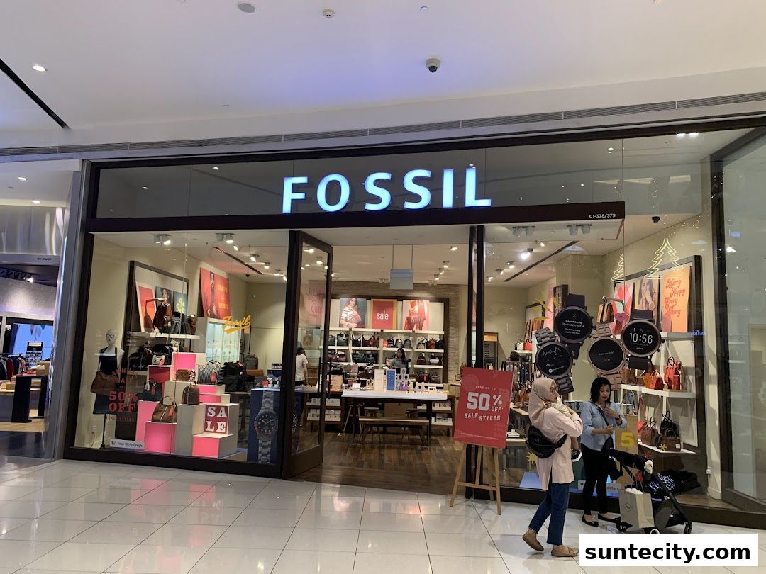 The Fossil store front displays watches, bags, and a "50% OFF SALE STYLES" sign.