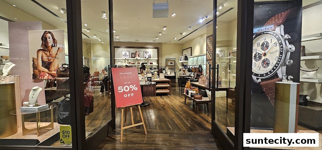 Fossil store interior showcasing watches, jewelry, and bags with a mid-season sale.
