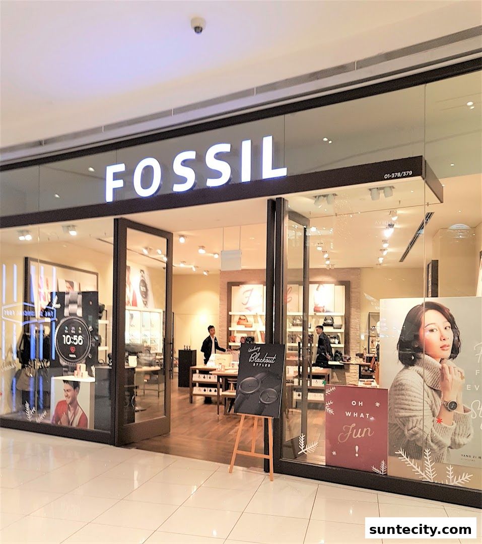 The Fossil store entrance with displays of watches and accessories, and promotional posters.