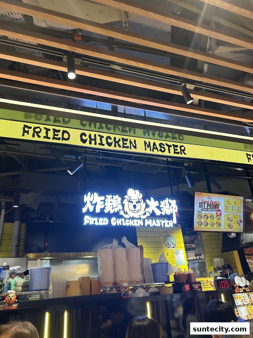 The exterior of Fried Chicken Master with its prominent signage and a promotional poster.