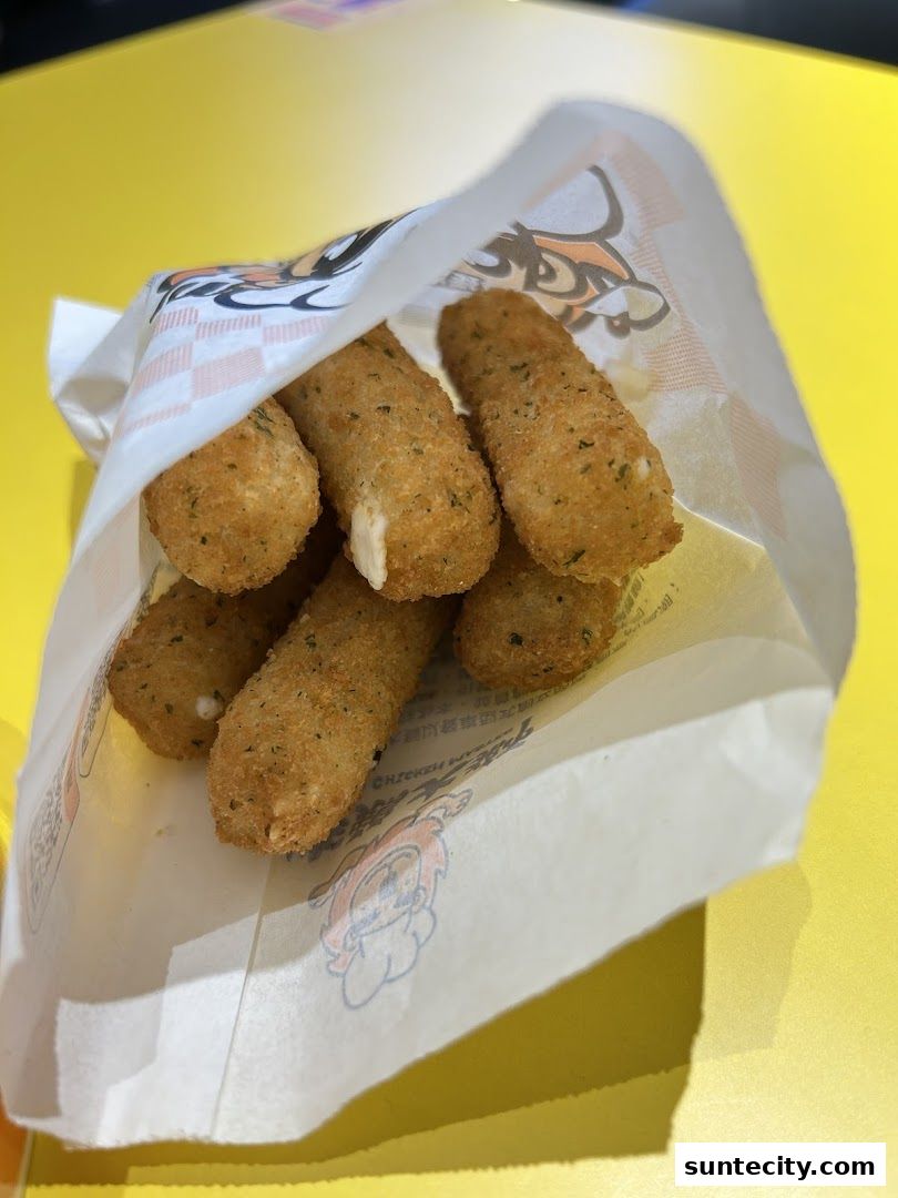 A bag of crispy fried mozzarella sticks with melted cheese oozing out.