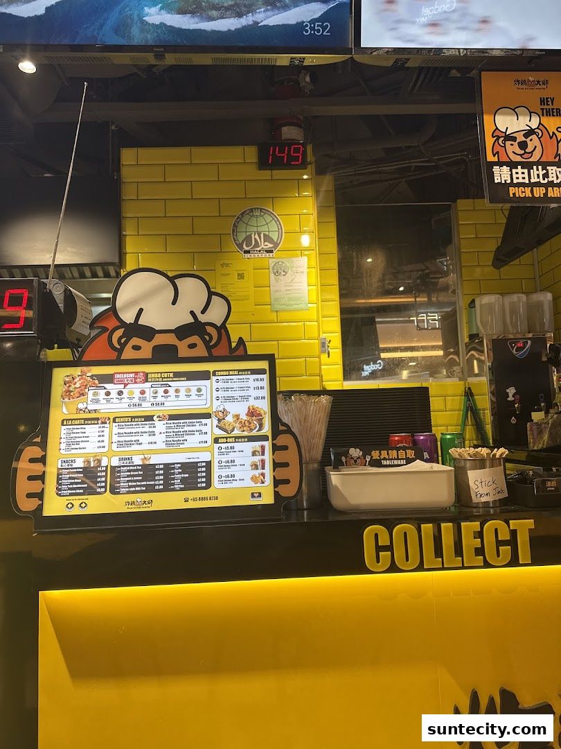 A bright yellow fried chicken shop counter with a menu and a 'Collect' sign.