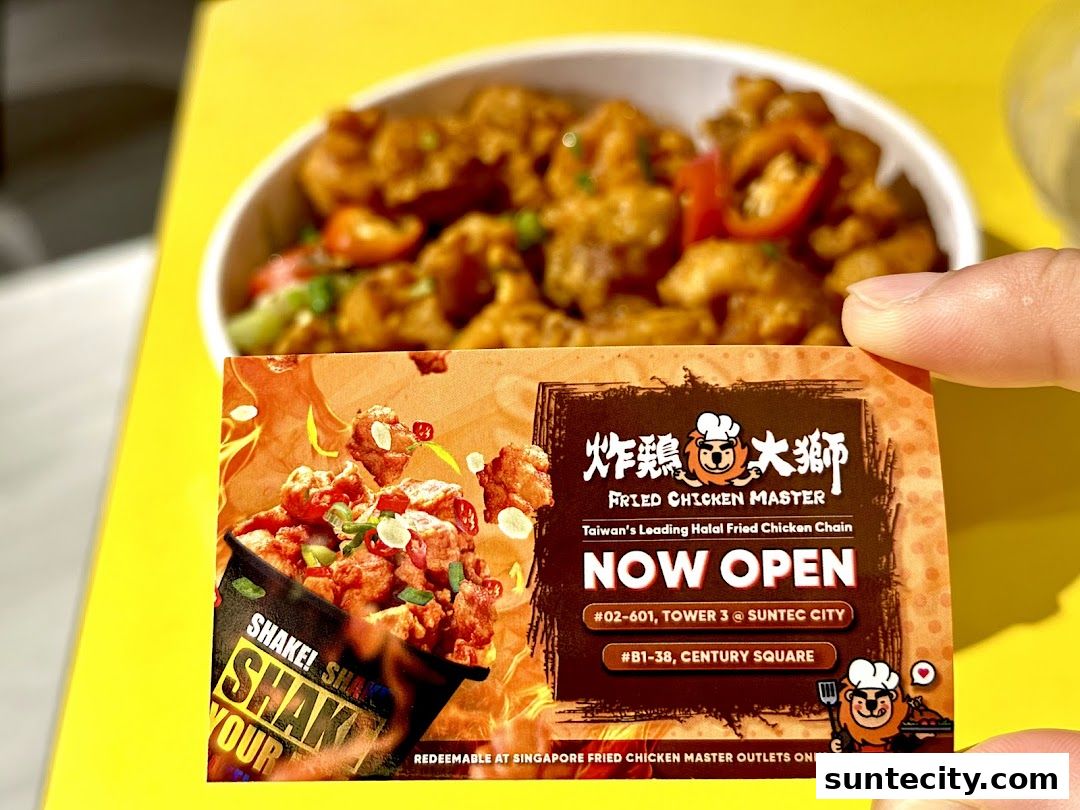 A hand holds a promotional card for Fried Chicken Master with a bowl of fried chicken in the background.