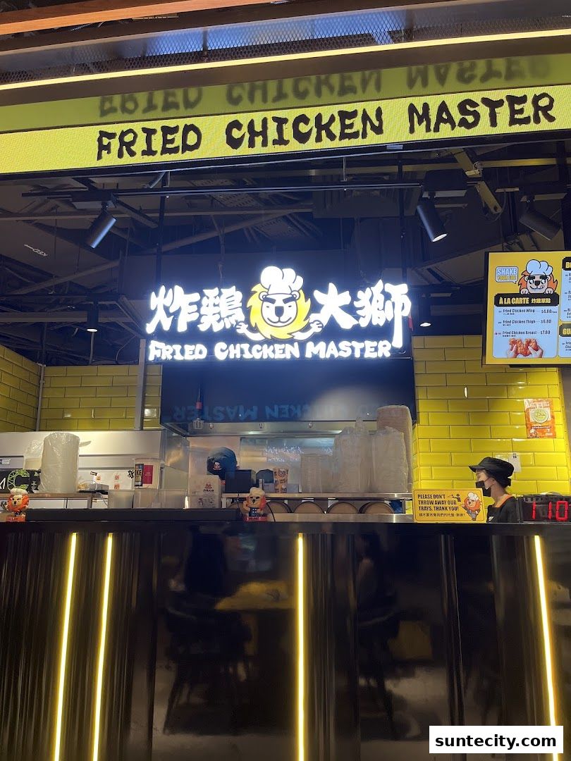 The exterior of Fried Chicken Master with its prominent signage and a menu board.