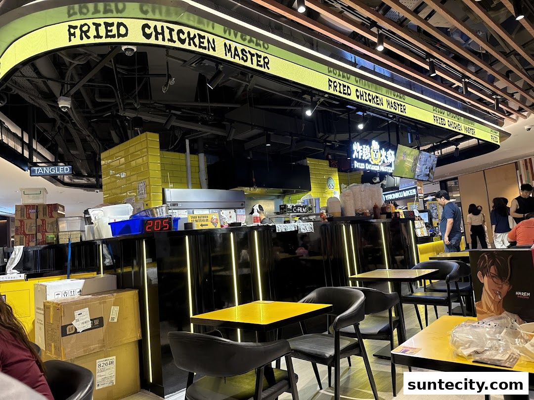 Interior view of Fried Chicken Master with seating, counter, and signage.