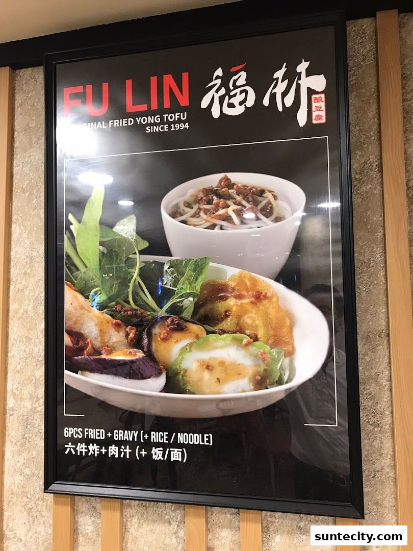 A framed poster showcasing a delicious Yong Tau Foo dish with accompanying rice or noodles.