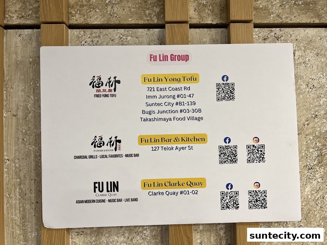A sign displaying contact information and locations for Fu Lin Group restaurants.