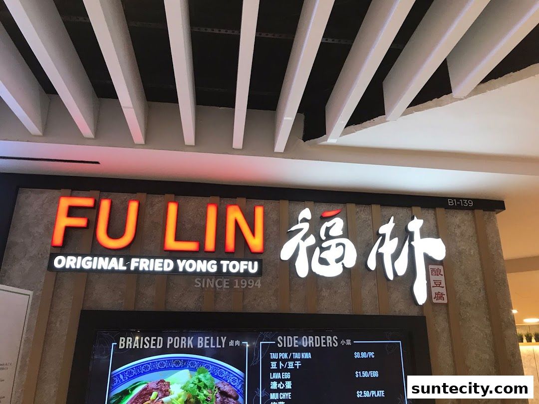The illuminated sign for FU LIN Original Fried Yong Tau Fu, featuring Chinese characters and a digital menu display.