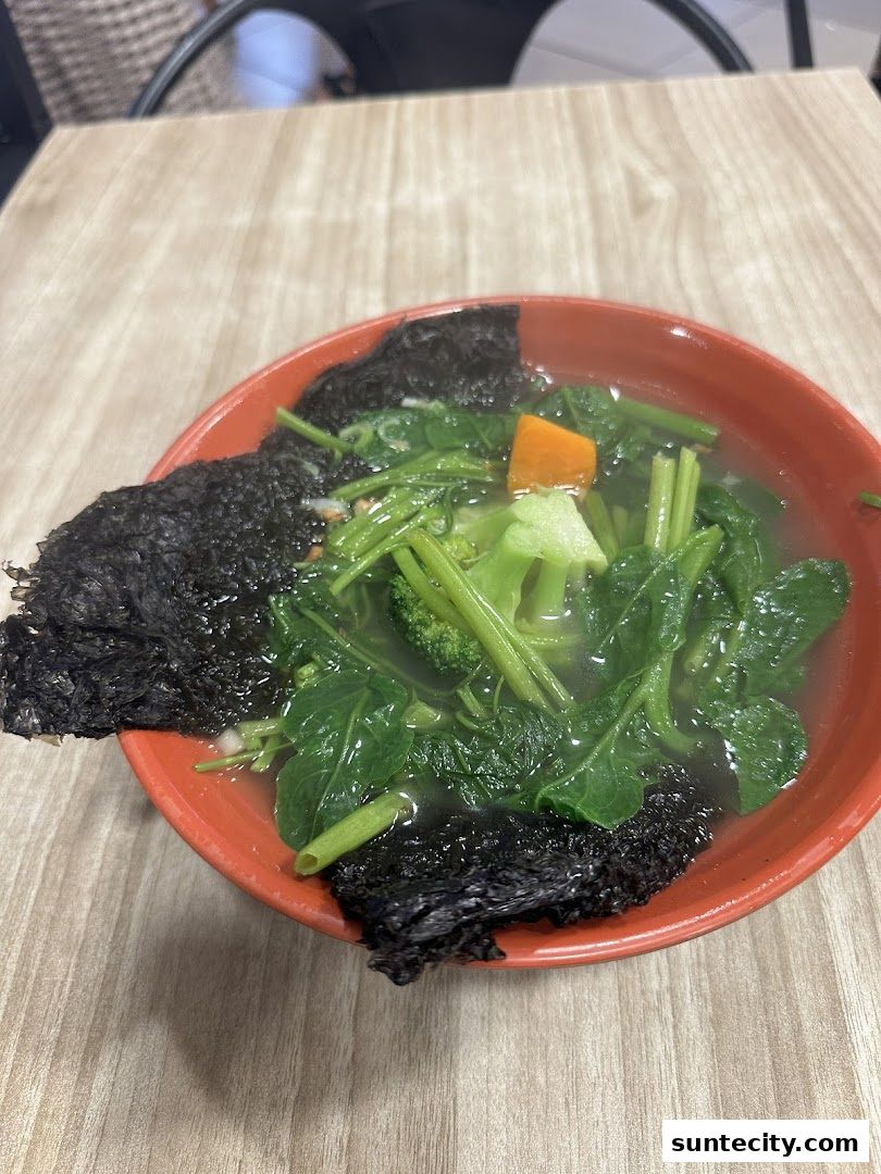 A close-up of a bowl of Yong Tau Foo with vegetables and seaweed.