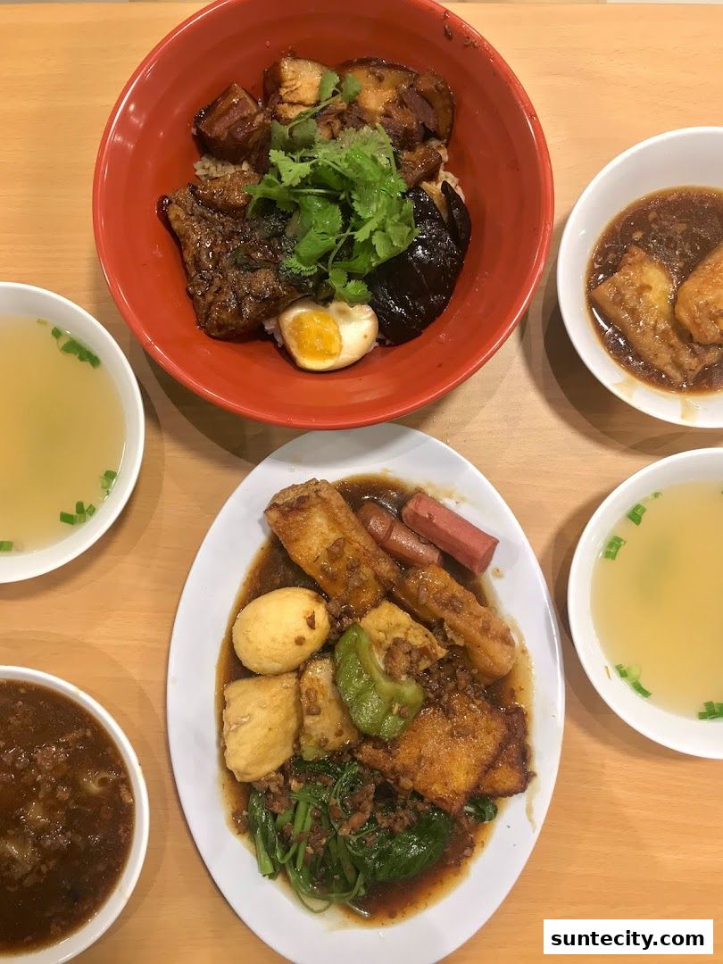 A top-down view of several bowls of Yong Tau Foo, showcasing a variety of ingredients and broth.