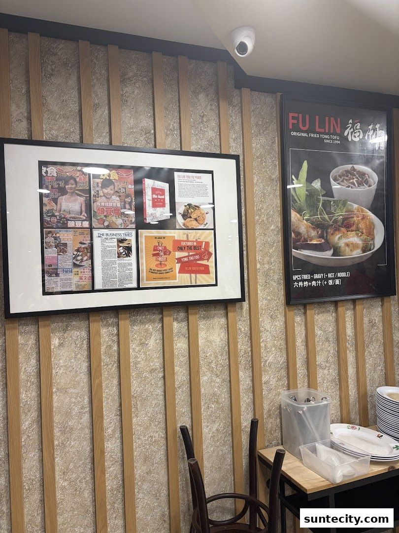 Interior shot of FU LIN Yong Tau Foo with framed articles and a menu poster.