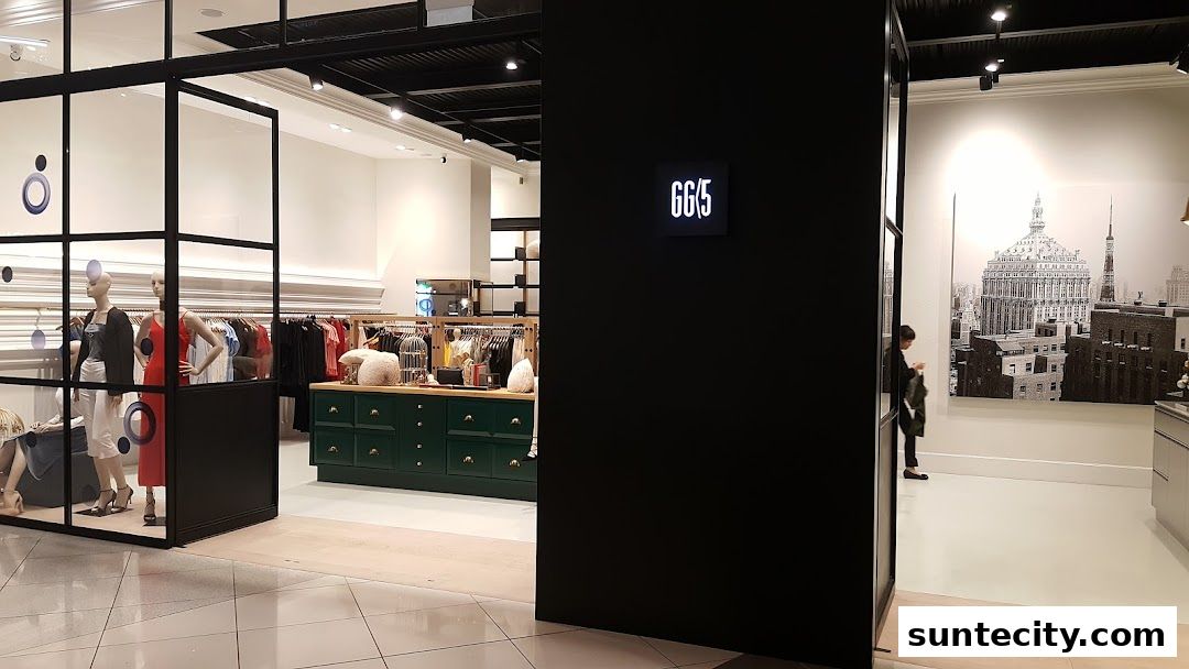 Interior view of a stylish clothing store with mannequins and clothing racks.