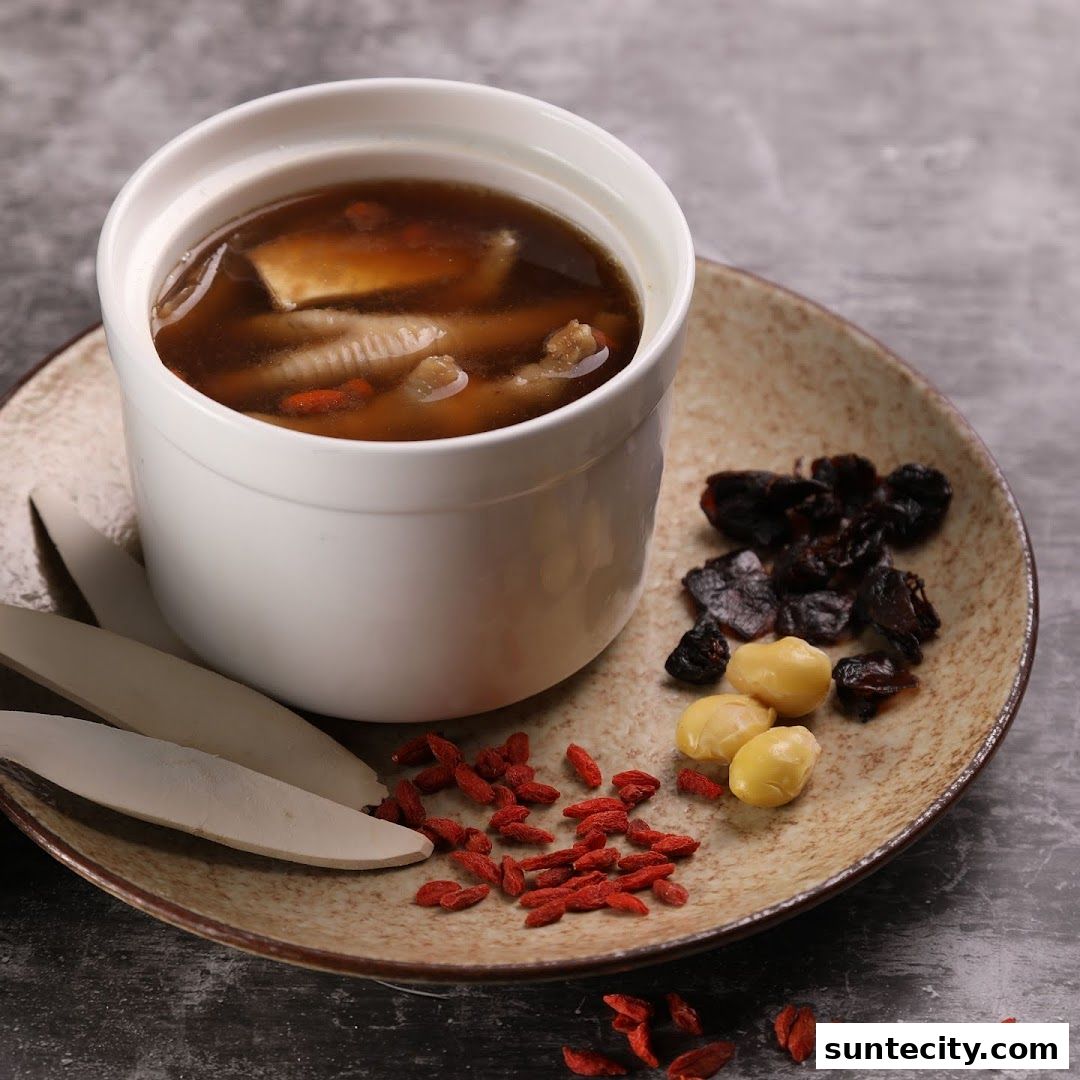 A bowl of nourishing chicken feet soup with goji berries, lotus seeds, and dried fruits.