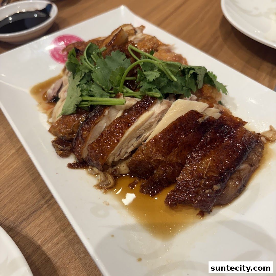 A plate of delicious, sliced roasted chicken with crispy skin and fresh cilantro.