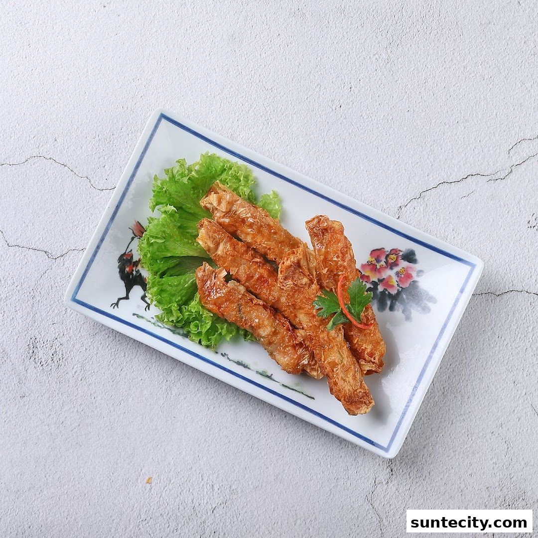 A plate of crispy fried spring rolls served with lettuce and garnished with cilantro.