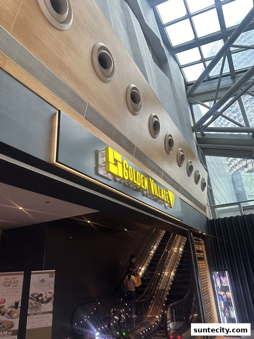 The Golden Village Suntec sign is visible above an escalator in a modern mall interior.