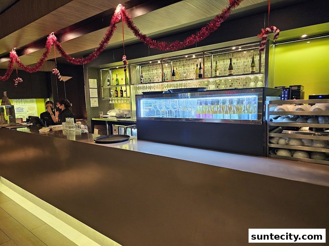 A bar area with staff, drinks, and festive decorations.