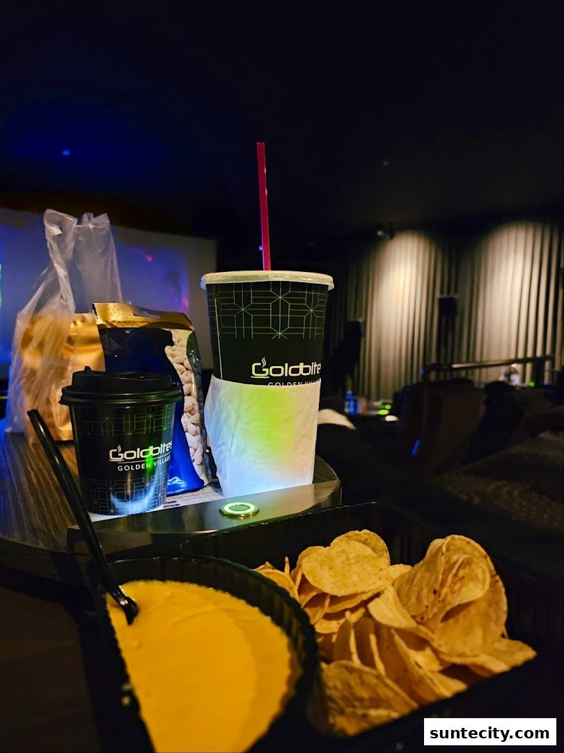 A tray of snacks and drinks, including chips and cheese dip, at Golden Village Suntec.