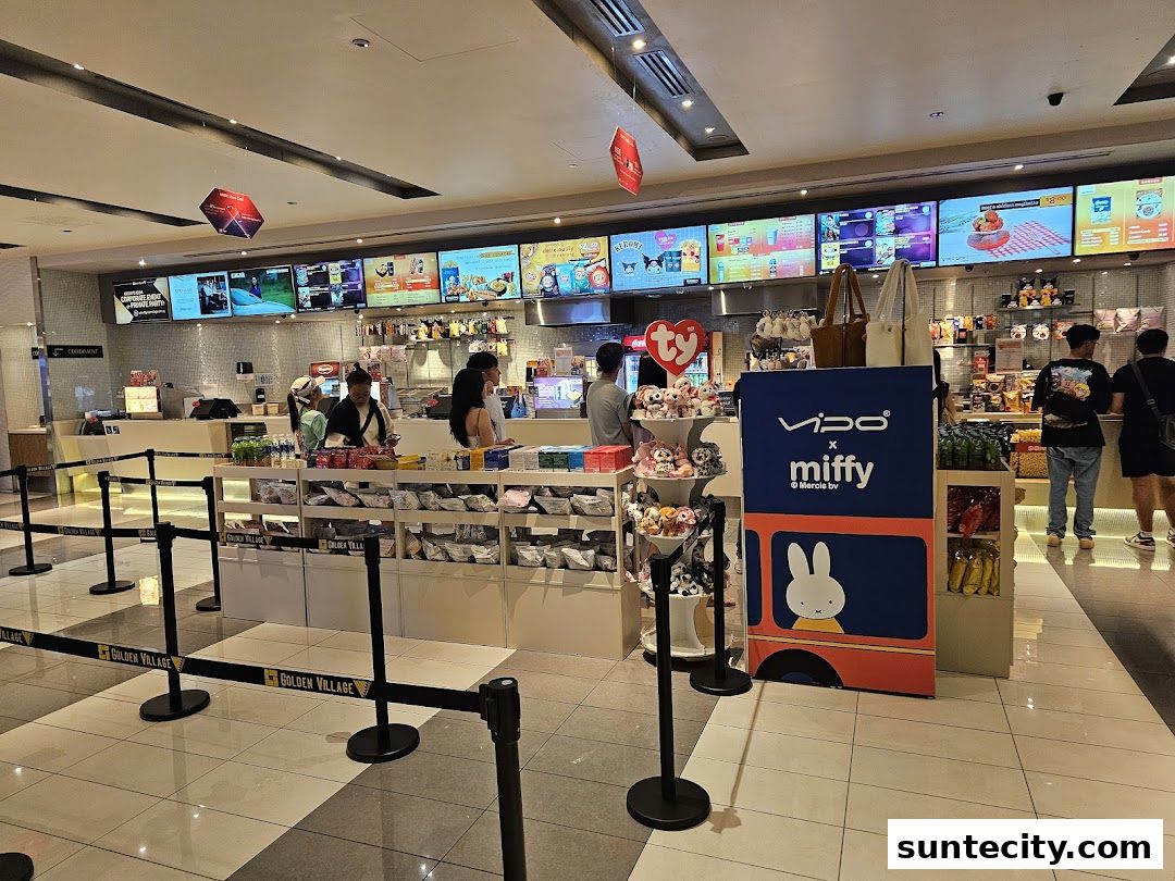 Interior view of a Golden Village cinema lobby with merchandise displays and a concession counter.