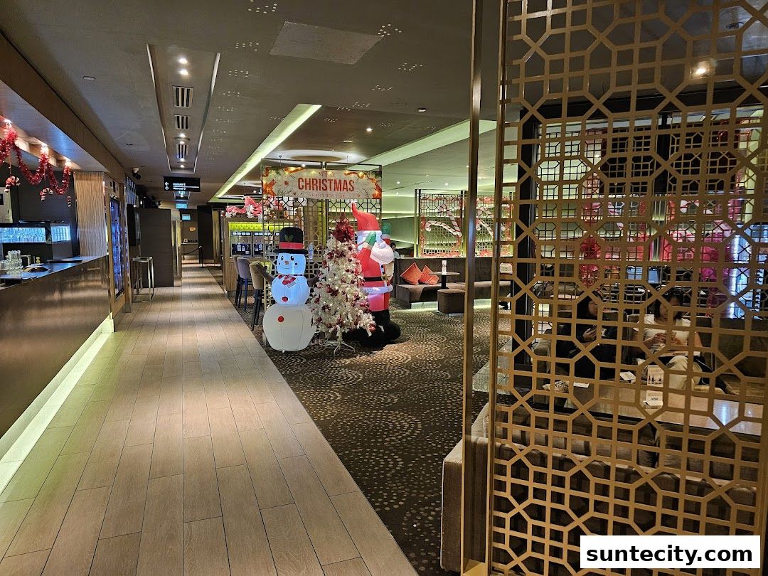 A festive Christmas display with a snowman and Santa Claus in a modern lounge.