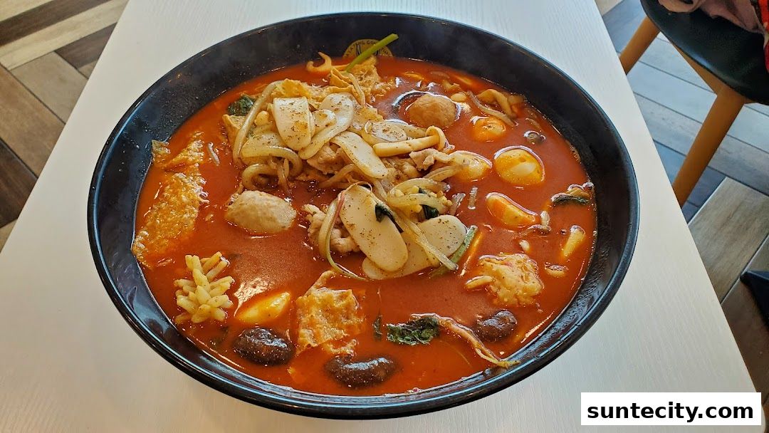 A steaming bowl of Mala Tang with various ingredients in a rich, red broth.