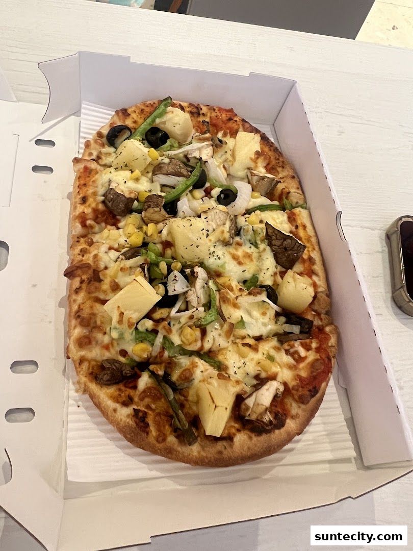 A delicious-looking pizza with various toppings in a white box.