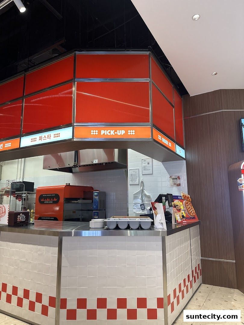 Interior view of a GOPIZZA counter with a pizza oven and ordering signs.