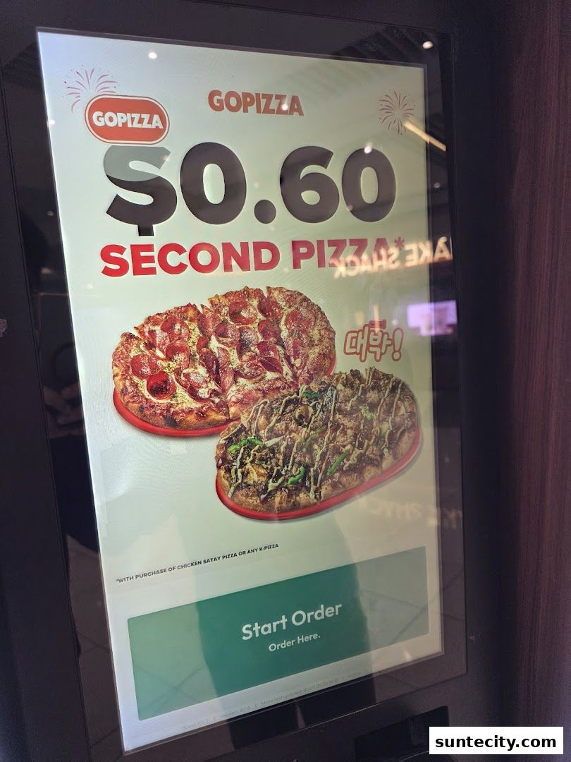 A digital display shows a promotion for a second pizza at GOPIZZA.