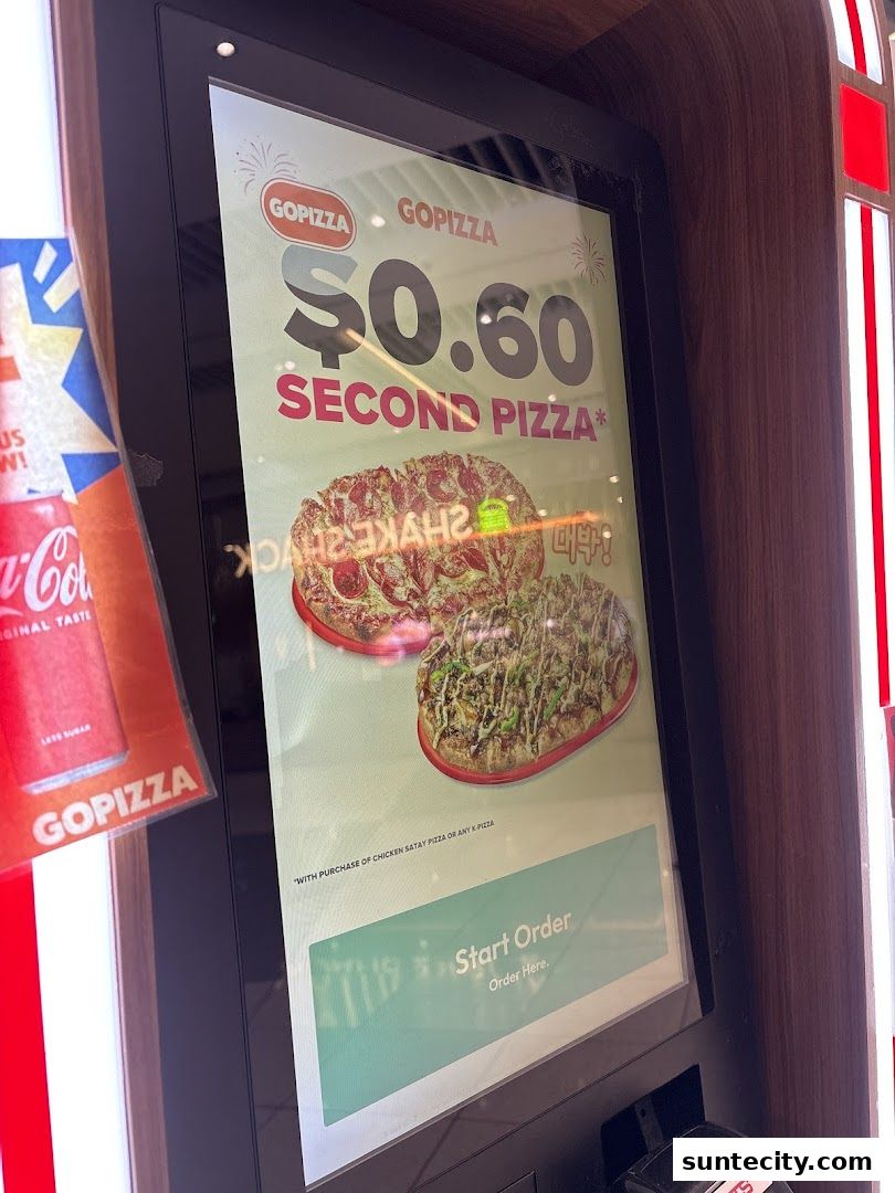 A digital display at GOPIZZA advertises a $0.60 second pizza deal.