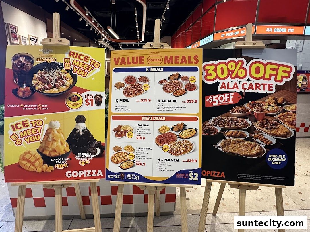 Three easels display promotional posters for GOPIZZA, showcasing meals, discounts, and desserts.