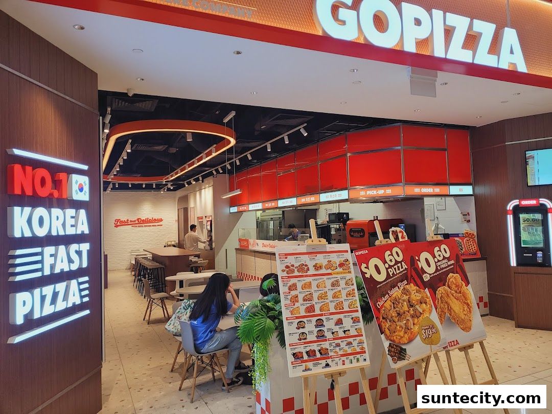 The entrance and interior of GOPIZZA, a Korean fast pizza restaurant, with menus displayed.