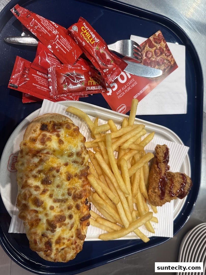 A tray of food from GOPIZZA featuring a cheesy pizza, french fries, and a piece of fried chicken with chili sauce.