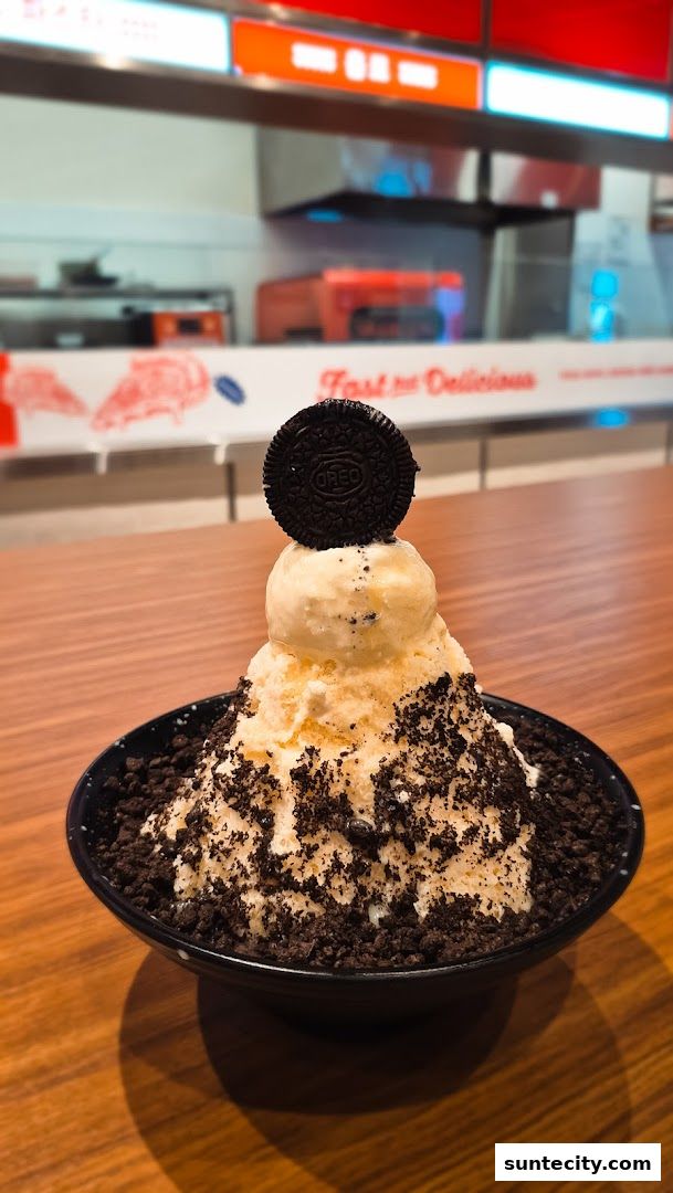 A delicious Oreo-themed shaved ice dessert topped with ice cream and an Oreo cookie.