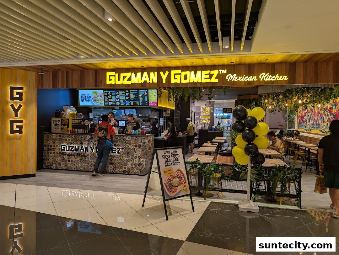 The exterior of a Guzman y Gomez Mexican Kitchen restaurant with a counter and seating area.