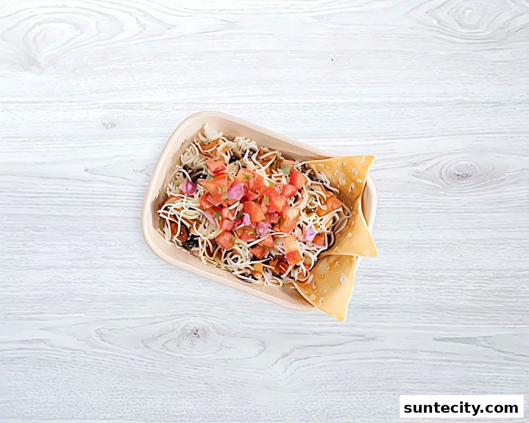 A close-up overhead view of a delicious Mexican-inspired dish in a takeaway container.