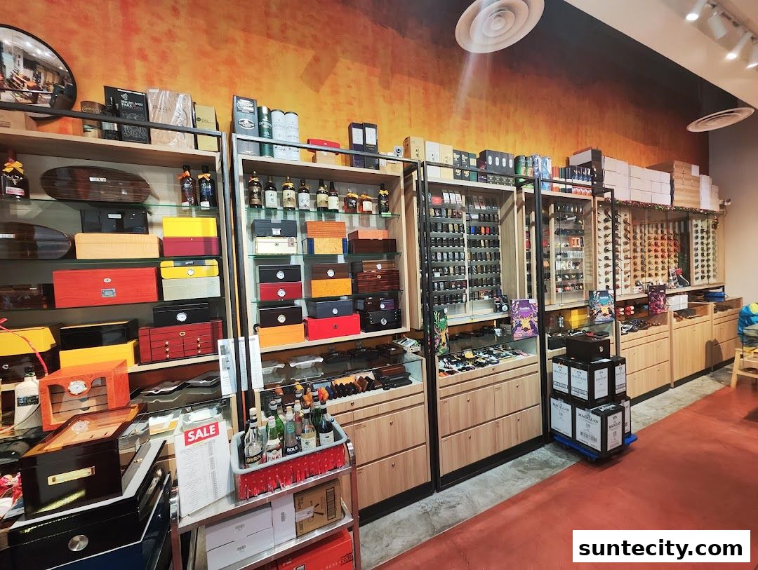 Interior of a shop displaying various cigar boxes, bottles, and accessories on shelves and in display cases.