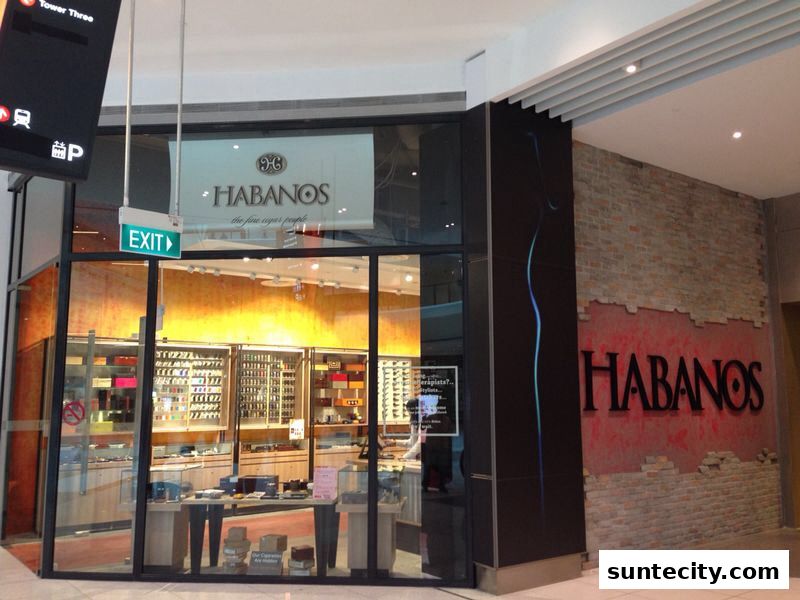 The Habanos shop front displays a wide selection of cigars and accessories in illuminated glass cabinets.