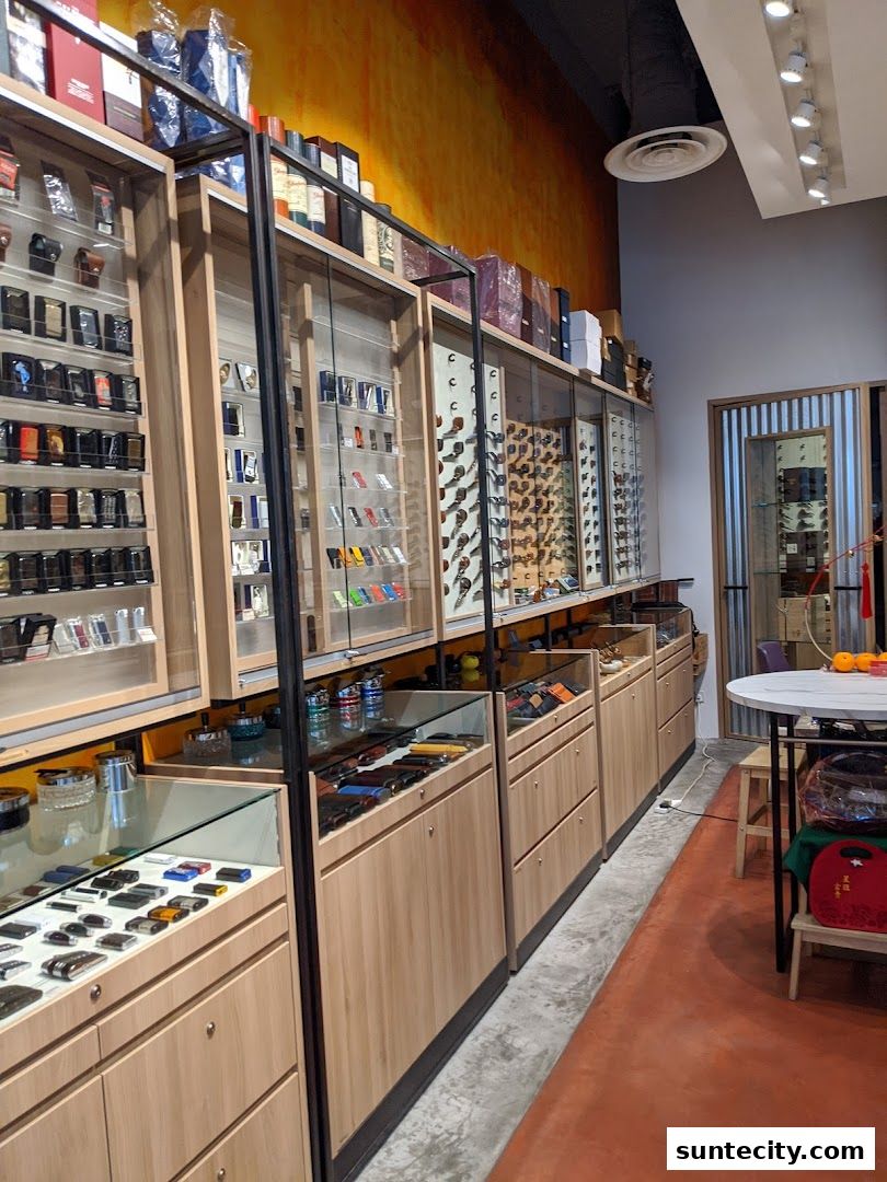 Interior view of a shop displaying lighters and accessories on shelves and in display cases.