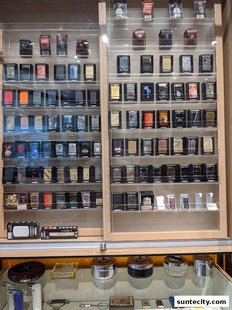 A display case filled with various Zippo lighters and accessories.