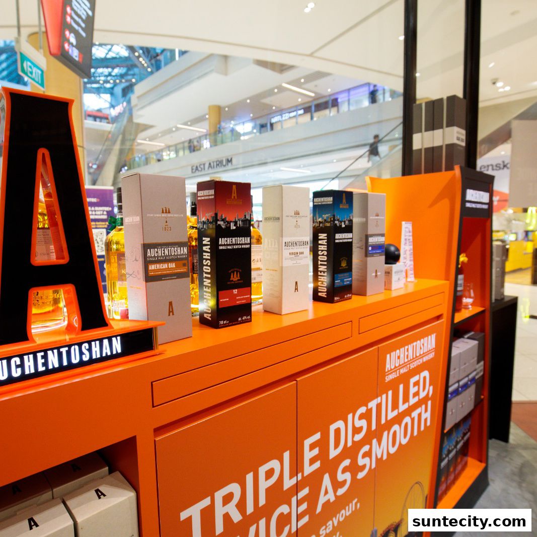 A display of Auchentoshan single malt Scotch whisky bottles and boxes in a retail setting.