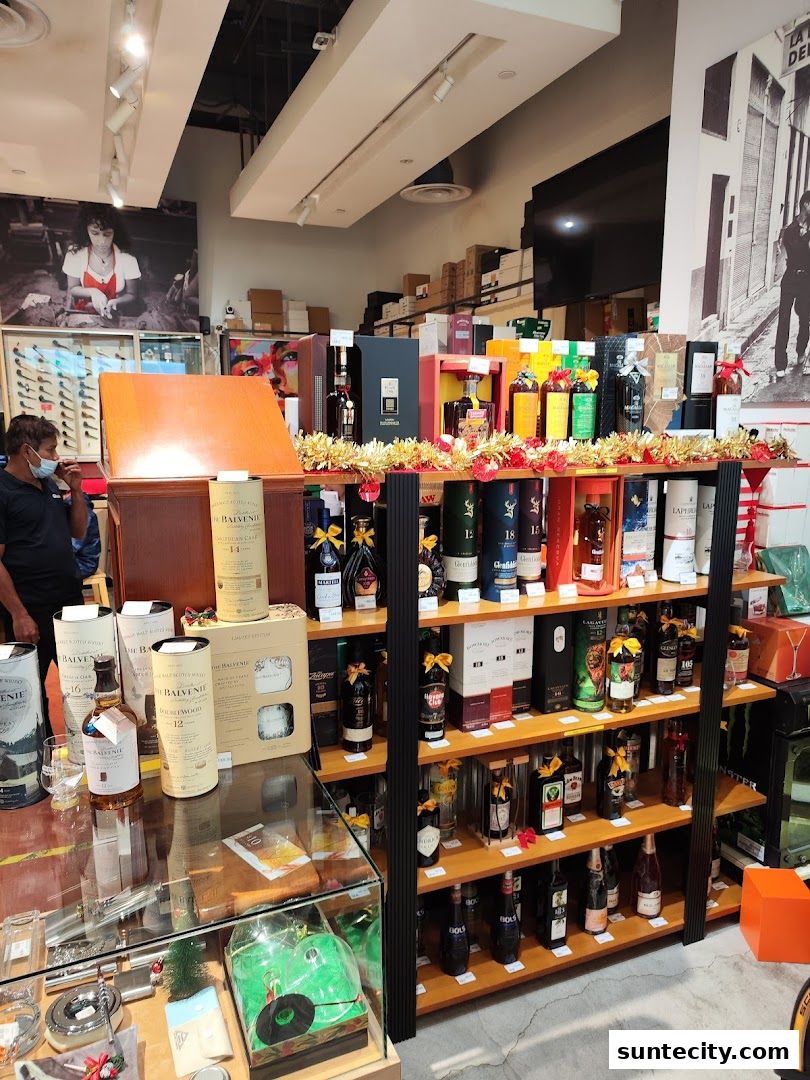 Interior of a liquor store with shelves stocked with various bottles of spirits and decorative items.