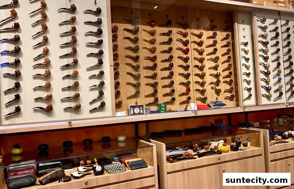 A display of numerous smoking pipes and accessories in a retail store.