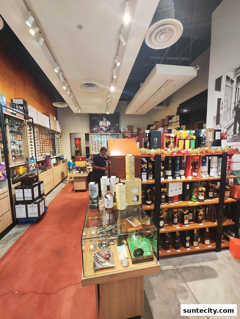 Interior view of a well-lit retail store showcasing shelves stocked with bottles and display cases.