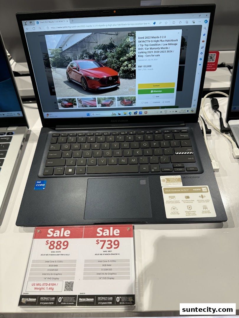 A laptop displaying a car for sale and two laptops on sale with their prices and specifications.