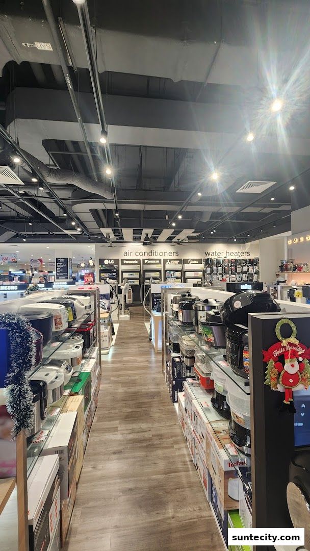 A wide aisle in an electronics store showcasing air conditioners and water heaters.