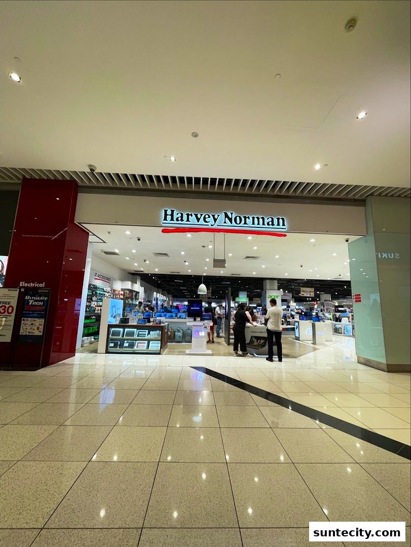 The entrance to Harvey Norman Suntec City, showcasing electronics and appliances.