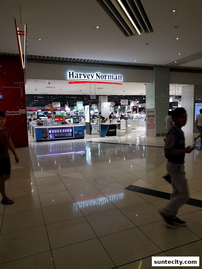 The entrance to Harvey Norman Suntec City, showcasing electronics and appliances.