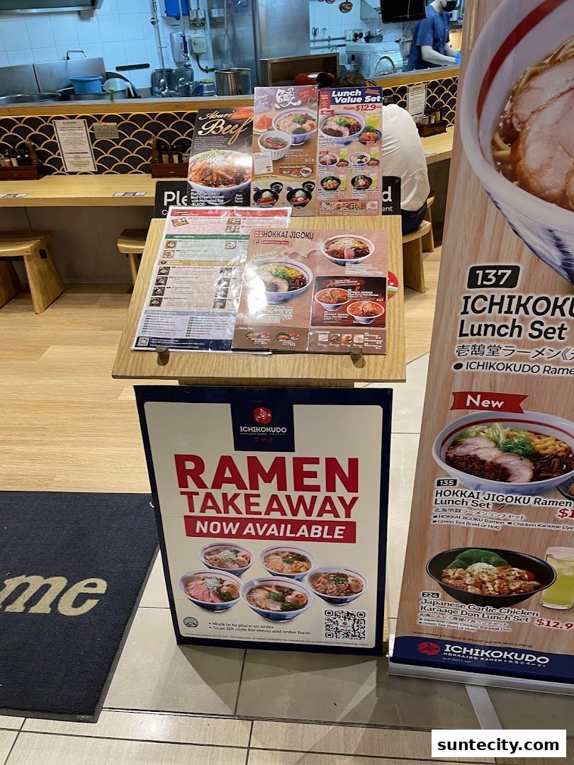 Ichikokudo Hokkaido Ramen shop with takeaway signage and menu displays.